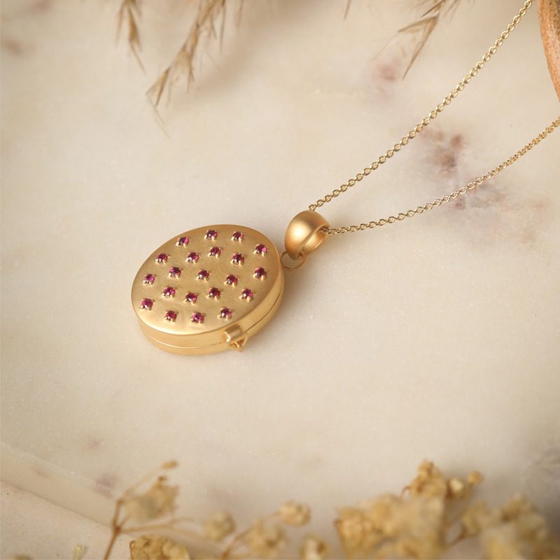 Adam Taweez - Gold featuring ruby detailing