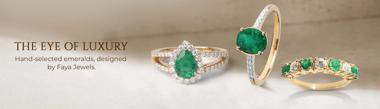 Three emerald rings with diamond accents on a beige background, featuring Faya Jewels branding.