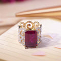 Gold ring with a red gemstone on a soft background