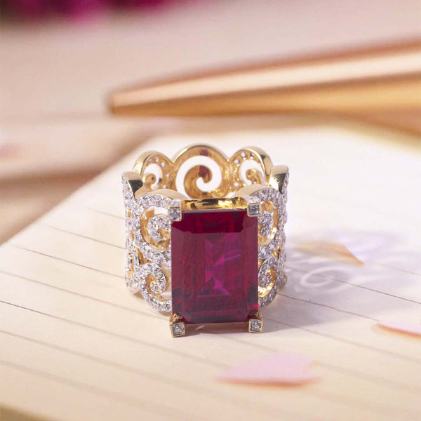 Gold ring with a red gemstone on a soft background
